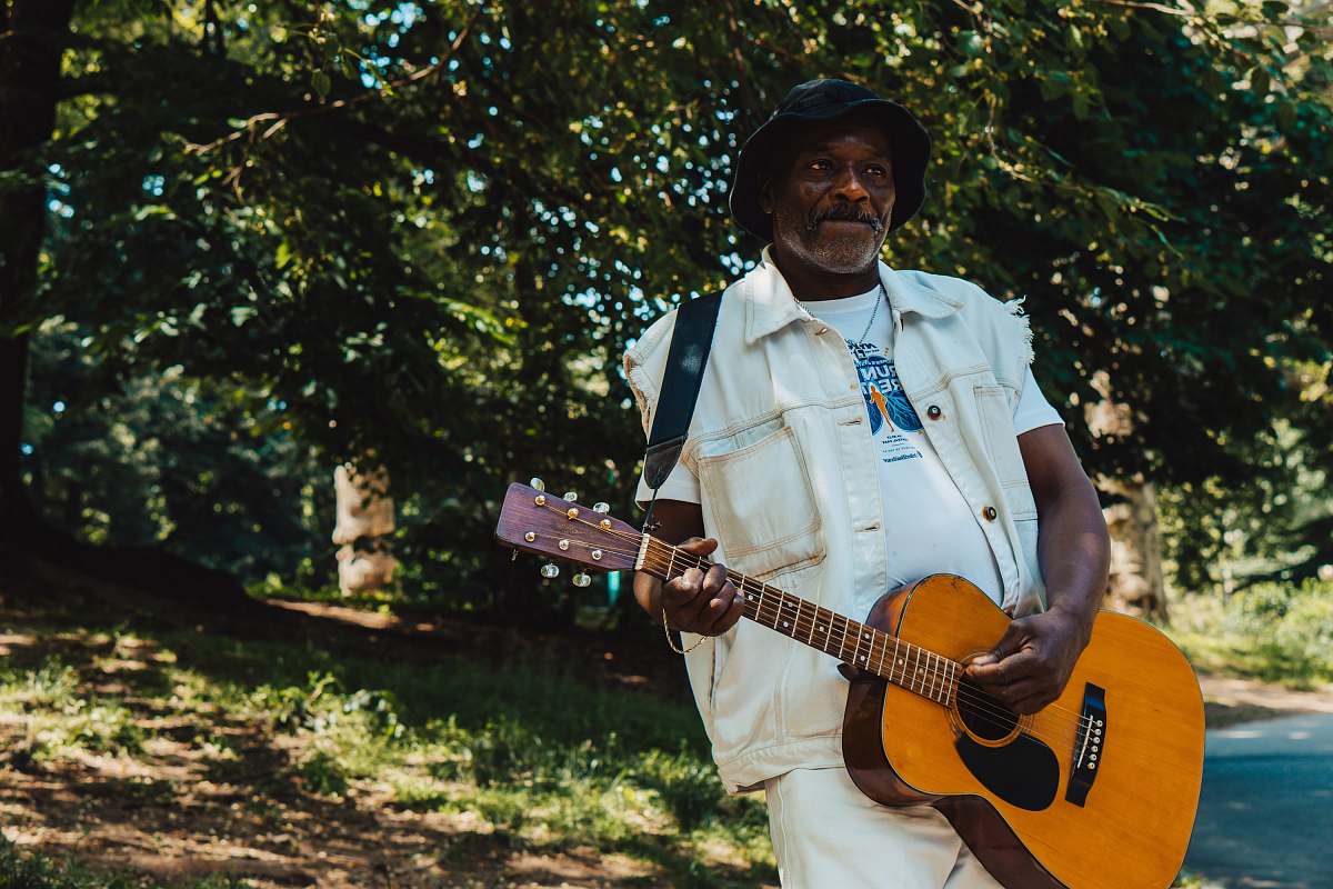guitar man standing and playing guitar during daytime leisure activities